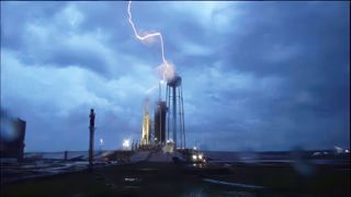 A lightning strikes the launch tower at pad 39A where SpaceX readies its Falcon Heavy rocket for launch.