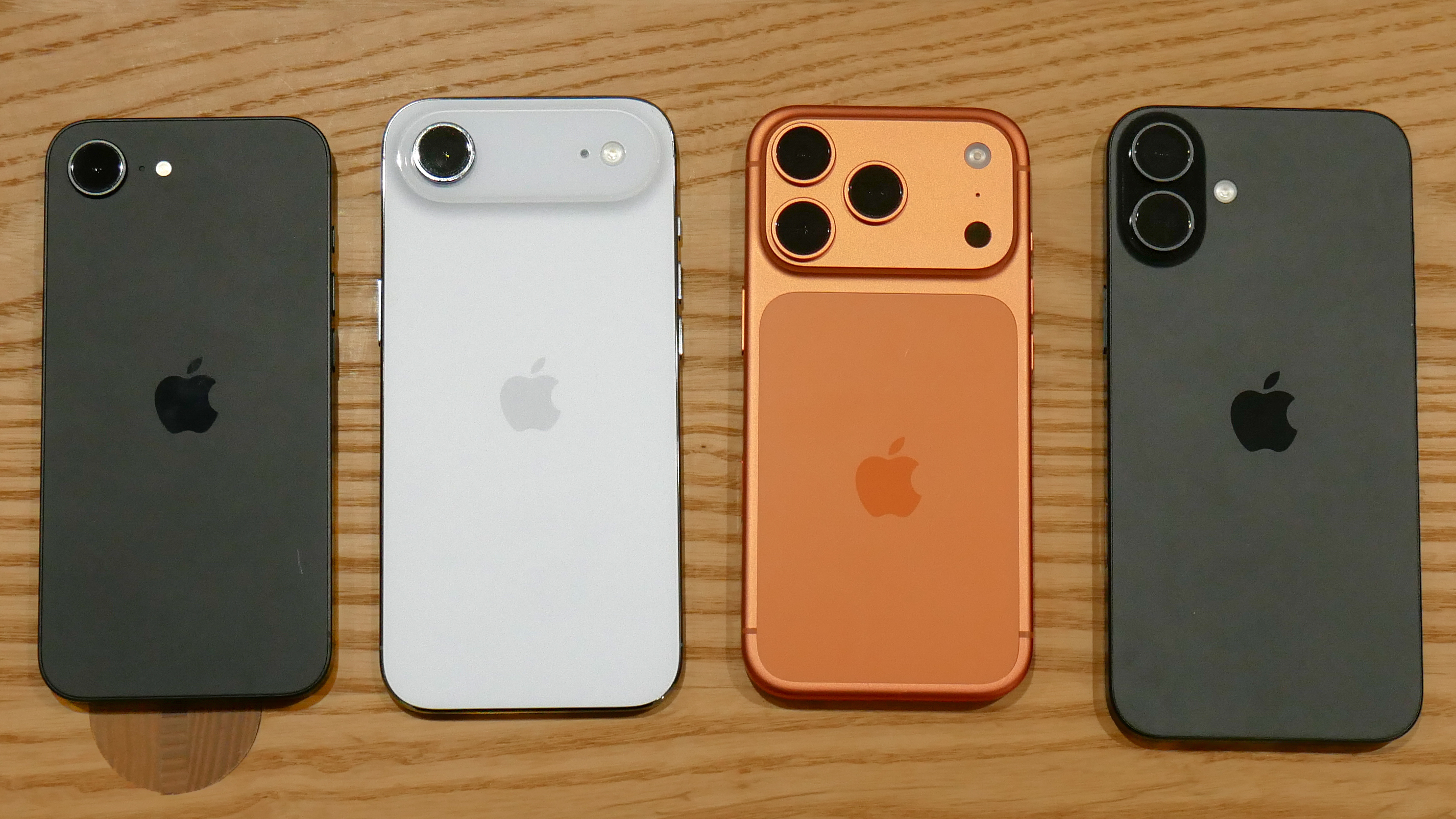 A bunch of iPhones held in the hand.