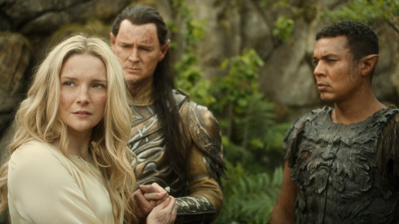 From left to right, Galadriel with Gil-galad and Arondir standing behind her looking at her.