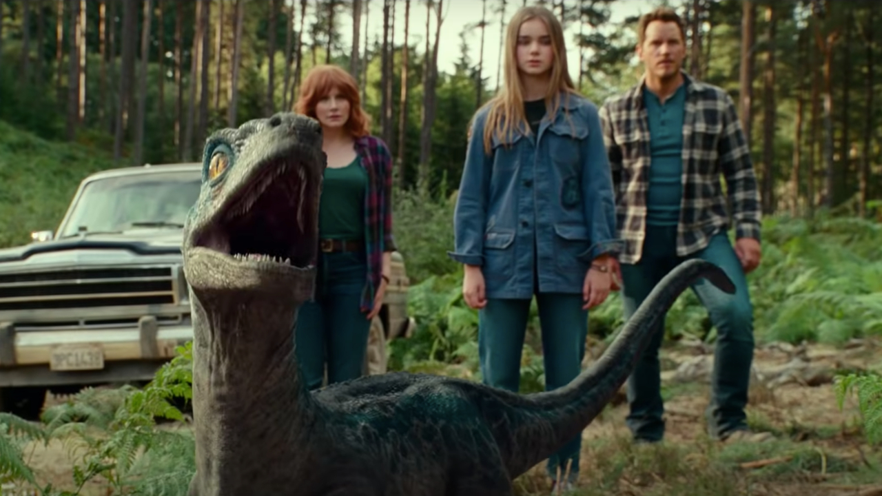 Bryce Dallas Howard, Isabella Sermon, and Chris Pratt watching the baby raptor in the woods in Jurassic World: Dominion.