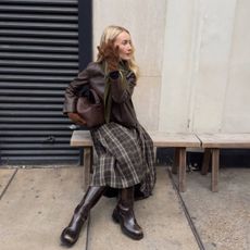 Chloe wearing checked skirt