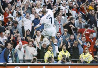 David Beckham celebrates in front of the England fans at Old Trafford after scoring against Greece in 2001.