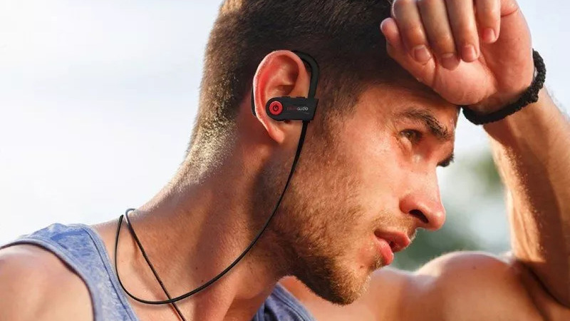 Man wearing Otium Bluetooth Headphones.