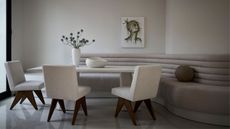 minimalist dining table with curved banquette seat