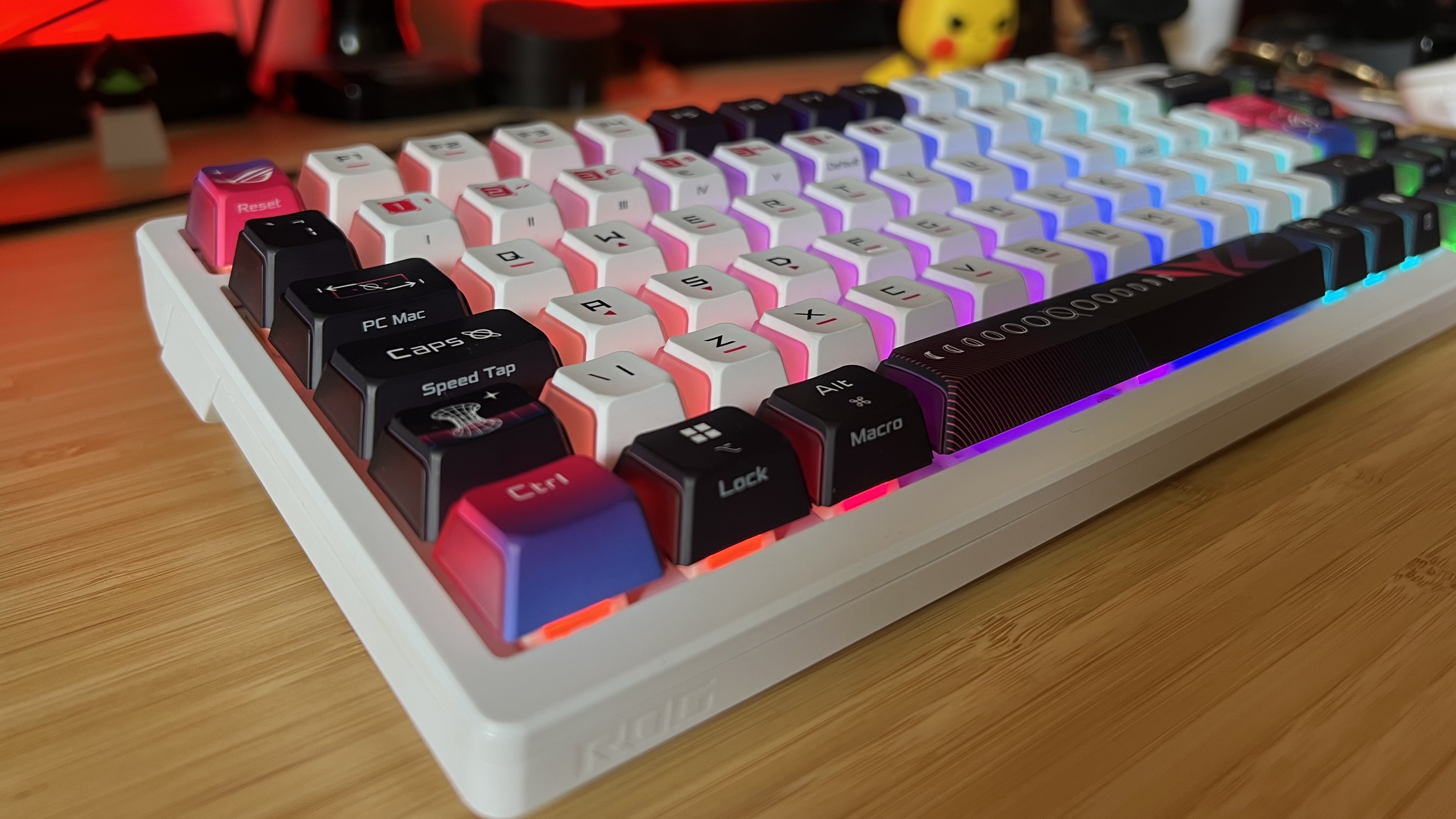 Asus ROG Azoth X gaming keyboard on a wooden desk