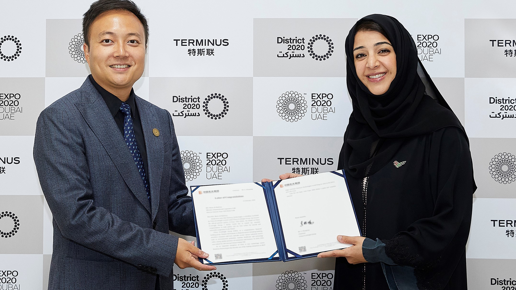 Reem Al Hashimy (right), Minister of State for International Cooperation, sign agreement with Victor Ai, Founder and CEO, Terminus Technologies, as Official Robotics Partner.