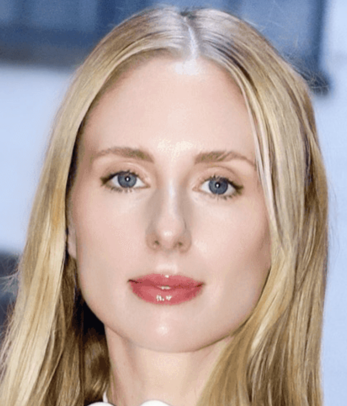 a blonde woman with pink lipstick and blue eyes