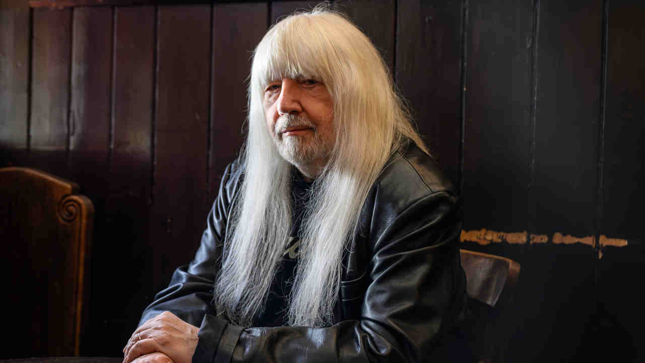 Sweet’s Andy Scott posing for a photograph in a bar in 2024