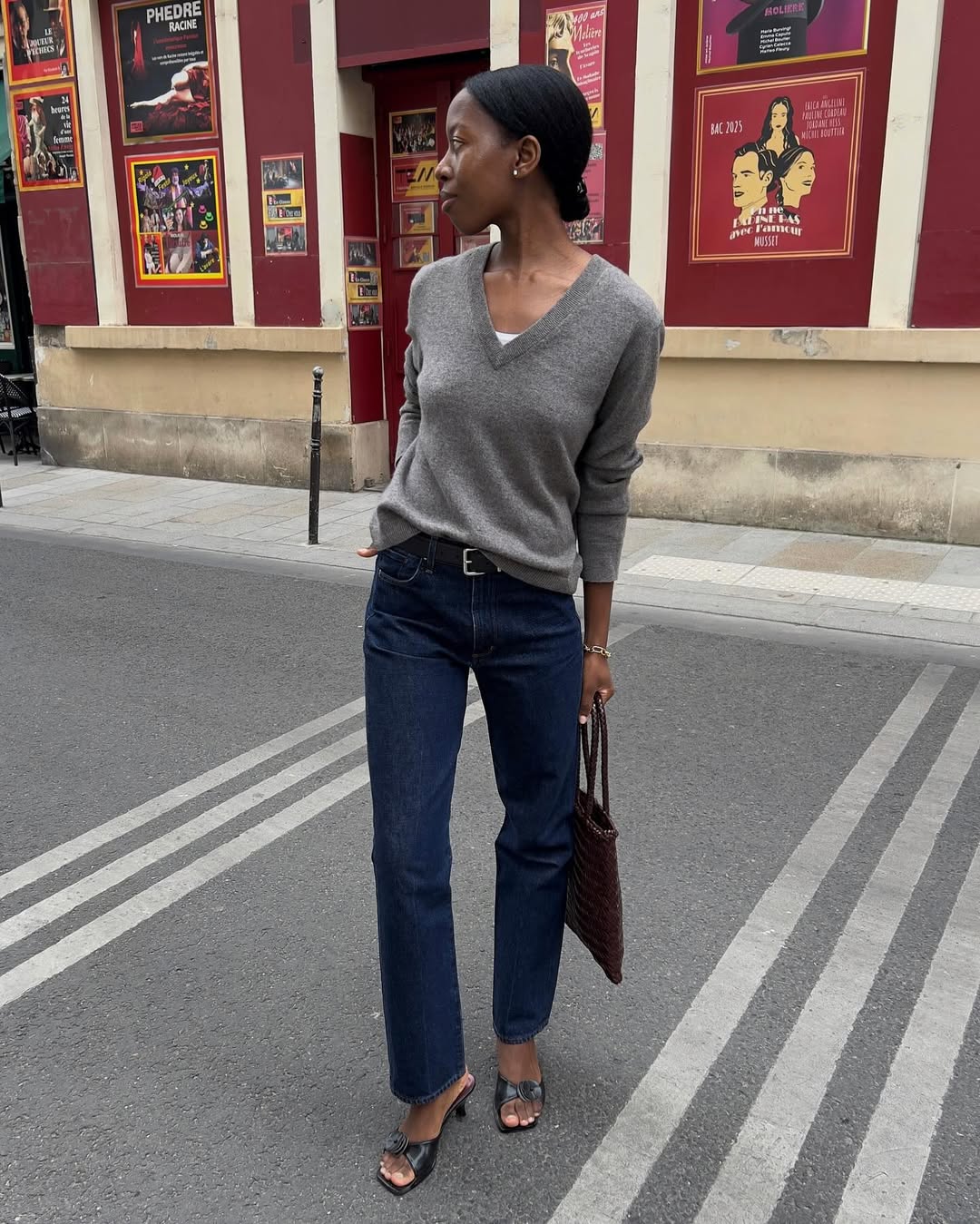 Influencer Sylvie Mus wearing dark-wash jeans and heeled sandals.