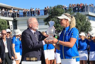 John Solheim hands Suzann Pettersen the Solheim Cup in 2023