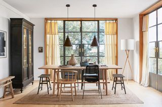 neutral dining room with crittall wooden furniture and pendant lamps