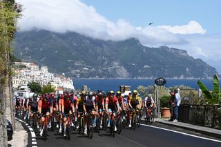 NAPLES ITALY MAY 11 Ben Swift of The United Kingdom Salvatore Puccio of Italy and Team INEOS Grenadiers Ryan Gibbons of South Africa and UAE Team Emirates Jasha Stterlin of Germany and Team Bahrain Victorious Thymen Arensman of The Netherlands and Team INEOS Grenadiers White Best Young Rider Jersey lead the peloton passing through Sorrento Village during the 106th Giro dItalia 2023 Stage 6 a 162km stage from Naples to Naples UCIWT on May 11 2023 in Naples Italy Photo by Tim de WaeleGetty Images