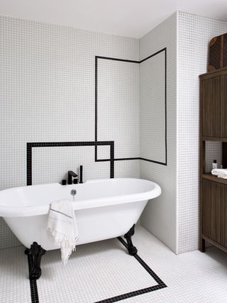 A bathroom with small pool like tiles