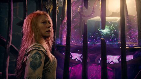Faye in God of War Laufey stands behind bars, with Phranque the cube in the background.