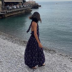 @aimeesong on the beach in a maxi dress and sandals