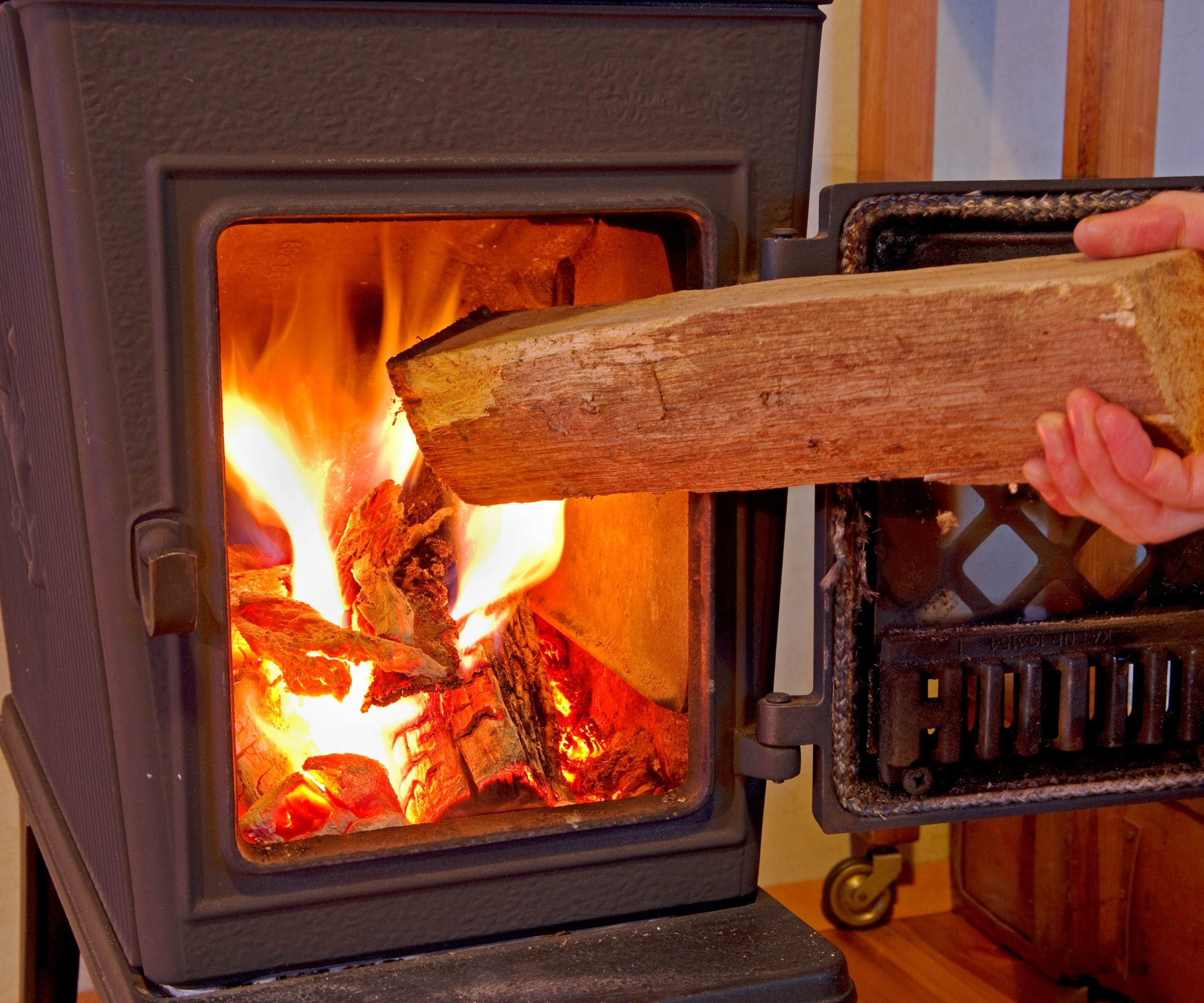 Firewood being placed into a log burner