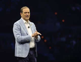 Cisco CEO Chuck Robbins speaking on stage at a large event