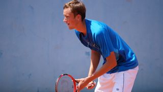 Basic image depicting Russian tennis player Daniil Medvedev preparing to return serve