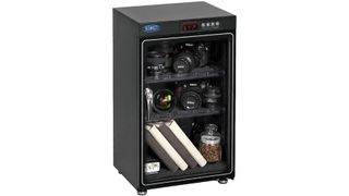 Sirui HC-70 Electronic Humidity Control Cabinet on white background, with cameras, lenses and other paraphernalia on shelves