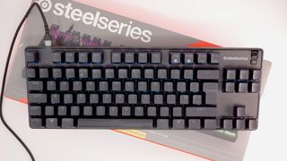 SteelSeries Apex 9 TKL gaming keyboard pictured on its box.