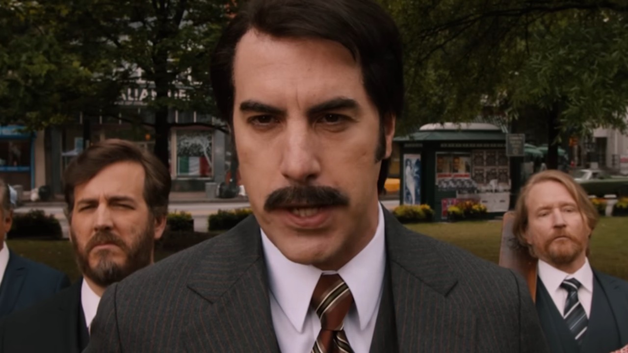 Sacha Baron Cohen representing BBC News in Anchorman 2: The Legend Continues