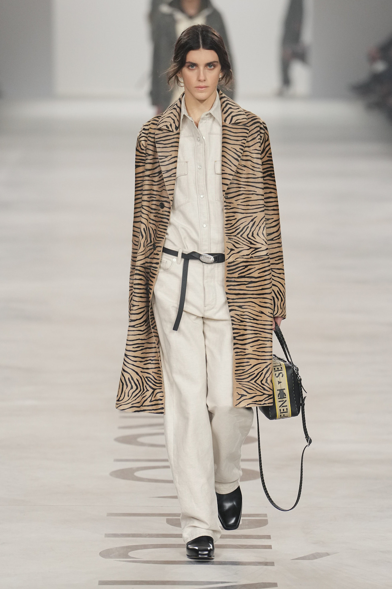 a model wearing a tiger striped fendi coat