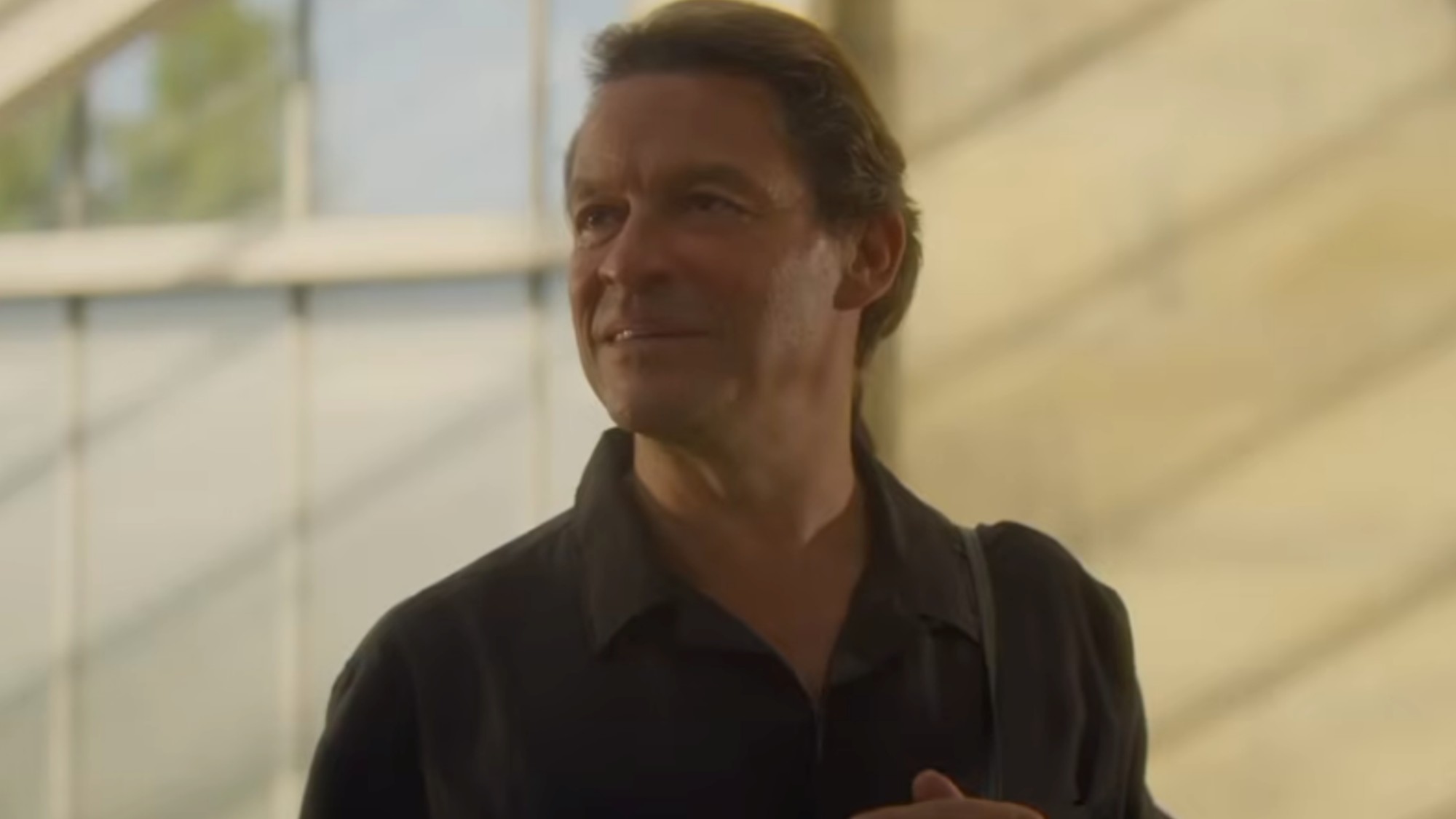 Dominic West smiling in Winds of Change
