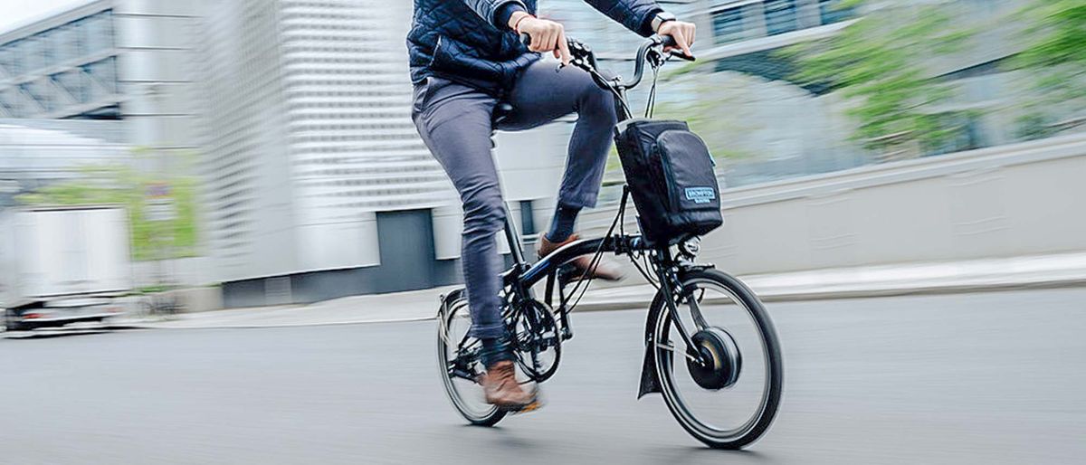 A man riding the Brompton Electric C Line Explore ebike in the street