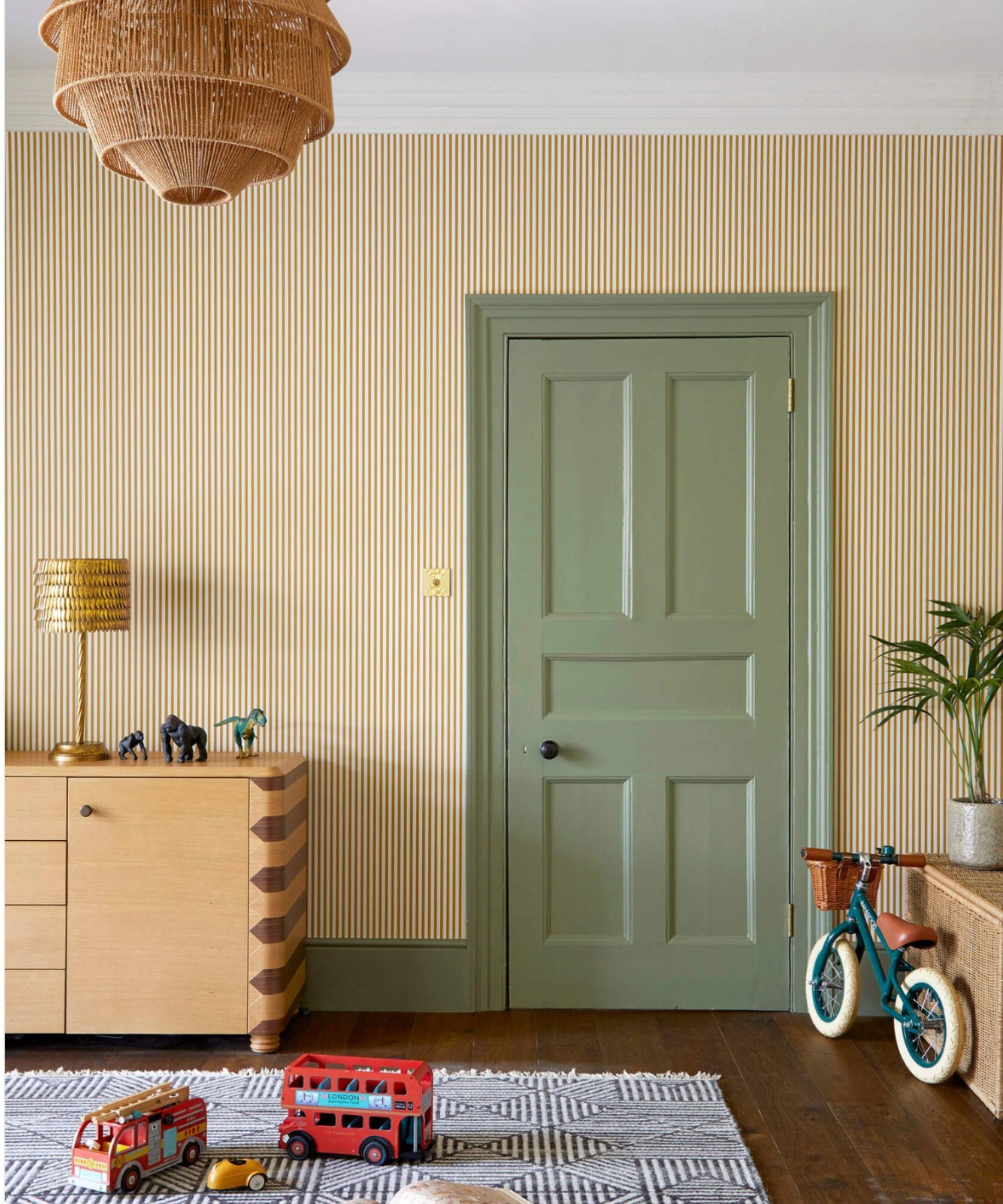 Child's nursery with yellow striped wallpaper