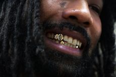 Man wearing teeth grillz he made at jewellery class