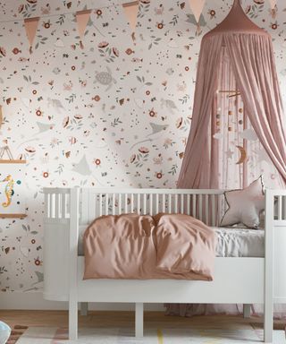 Girls nursery ideas: Dreamy sea life printed wallpaper in nursery with cot by Bobby Rabbit
