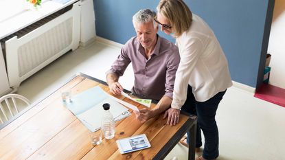 A couple look over paperwork together.