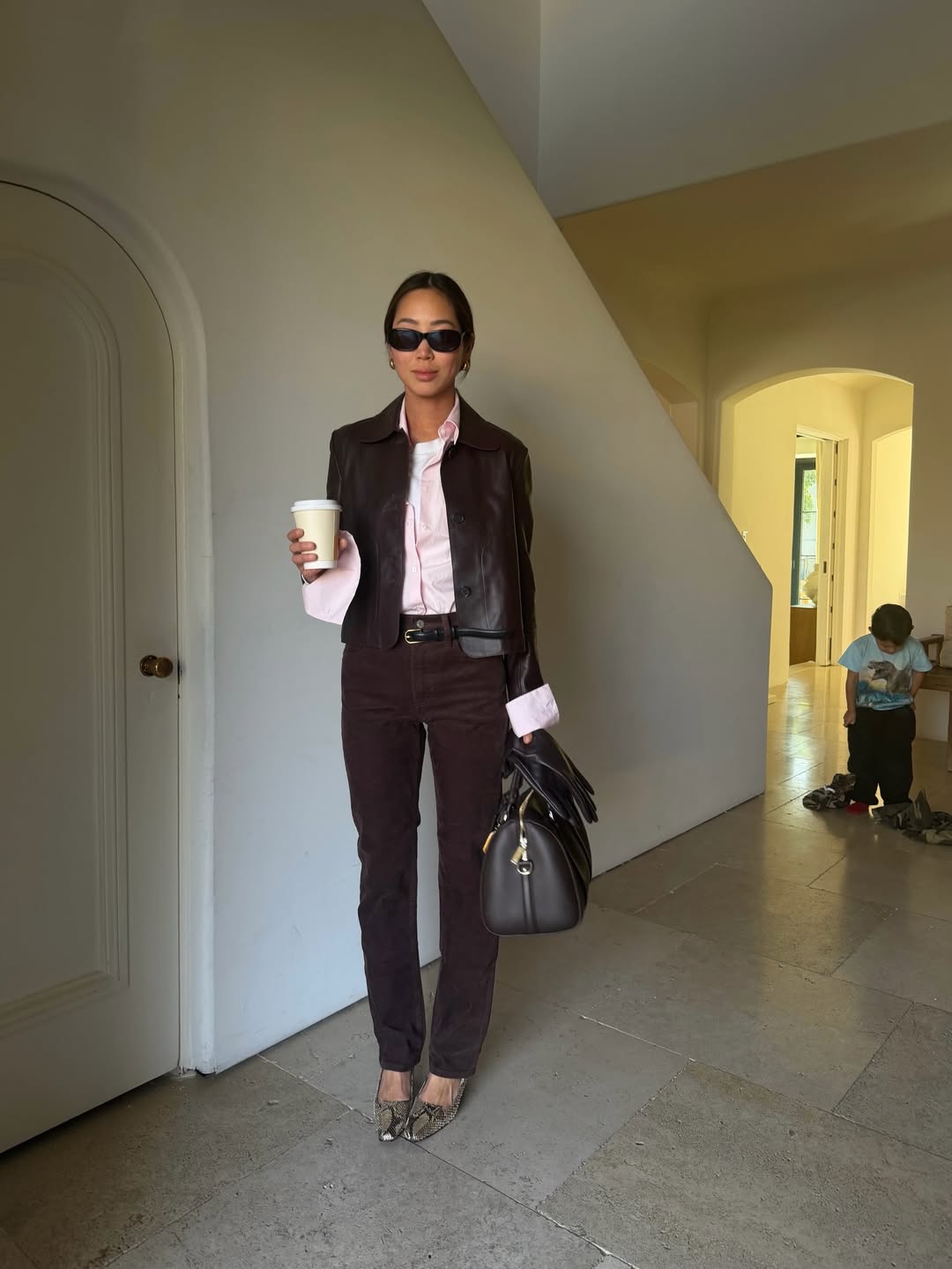 @aimeesong wears brown jeans, pink shirt, snake print heels