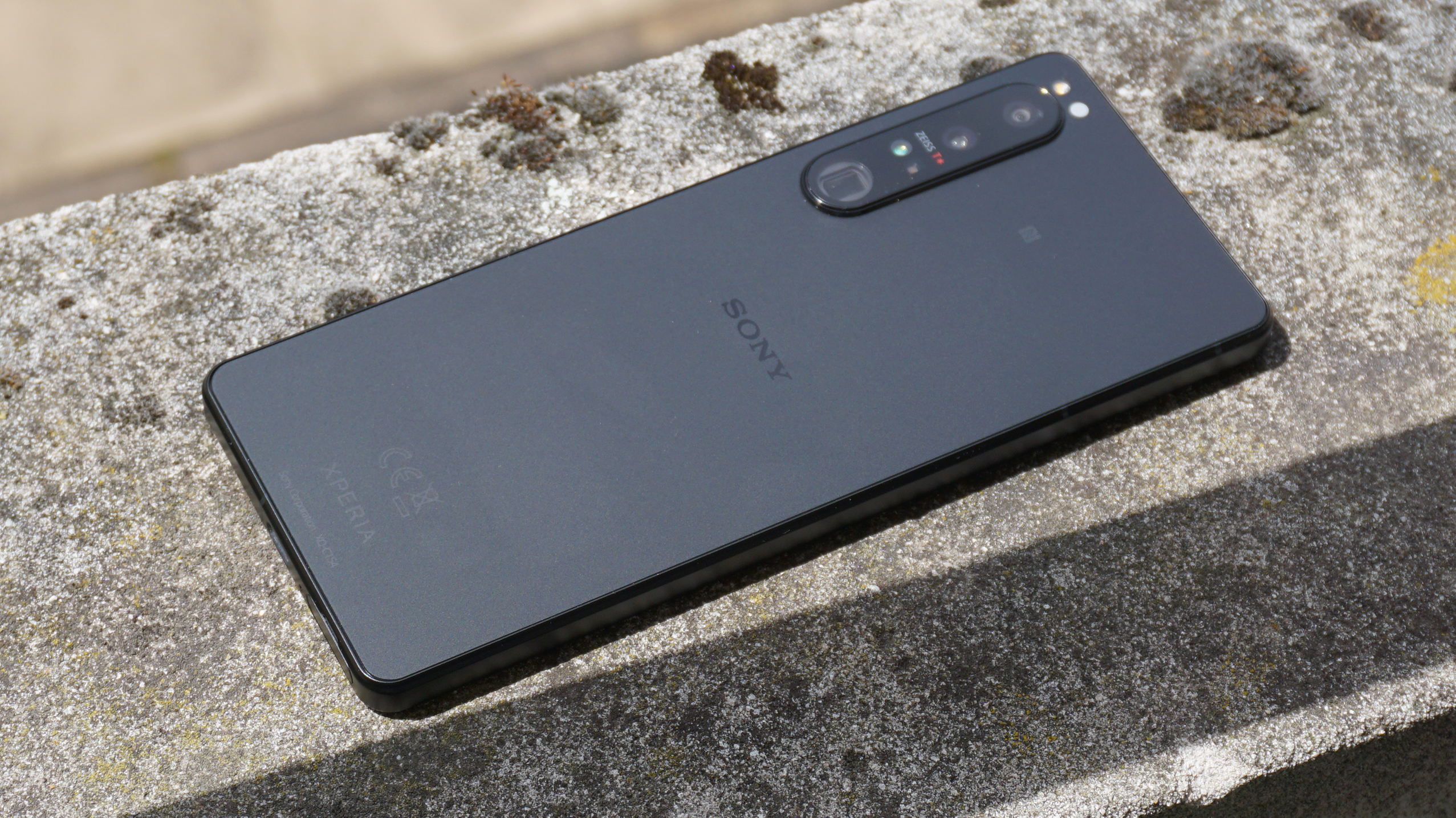 A Sony Xperia 1 IV from the back, lying on a stone surface