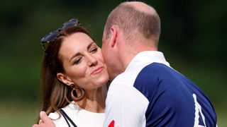 Catherine, Duchess of Cambridge kisses Prince William, Duke of Cambridge during the prize-giving of the Out-Sourcing Inc. Royal Charity Polo Cup