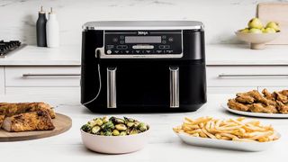 Ninja DZ550 air fryer with Foodi thermometer in chicken