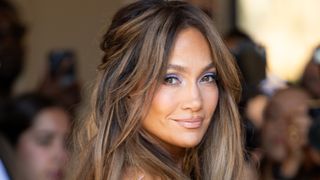 Jennifer Lopez stares right at the cameras while dressed to the nines at 2026 Paris Fashion week. 