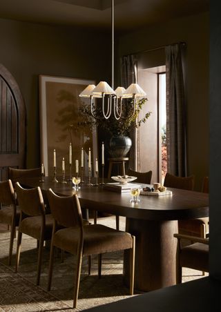 dining room with chandelier, timber dining table, upholstered dining chairs and candlesticks