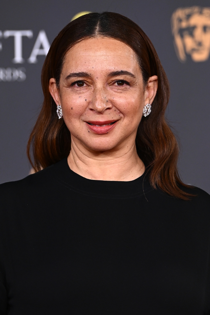 Maya Rudolph is pictured with shimmery brow eyeshadow and with a rosy lip, and wearing a black dress at the EE BAFTA Film Awards 2026 at The Royal Festival Hall on February 22, 2026 in London, England.
