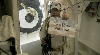 A member of the shuttle Atlantis' close-out crew shares a message before the shuttle's last launch.