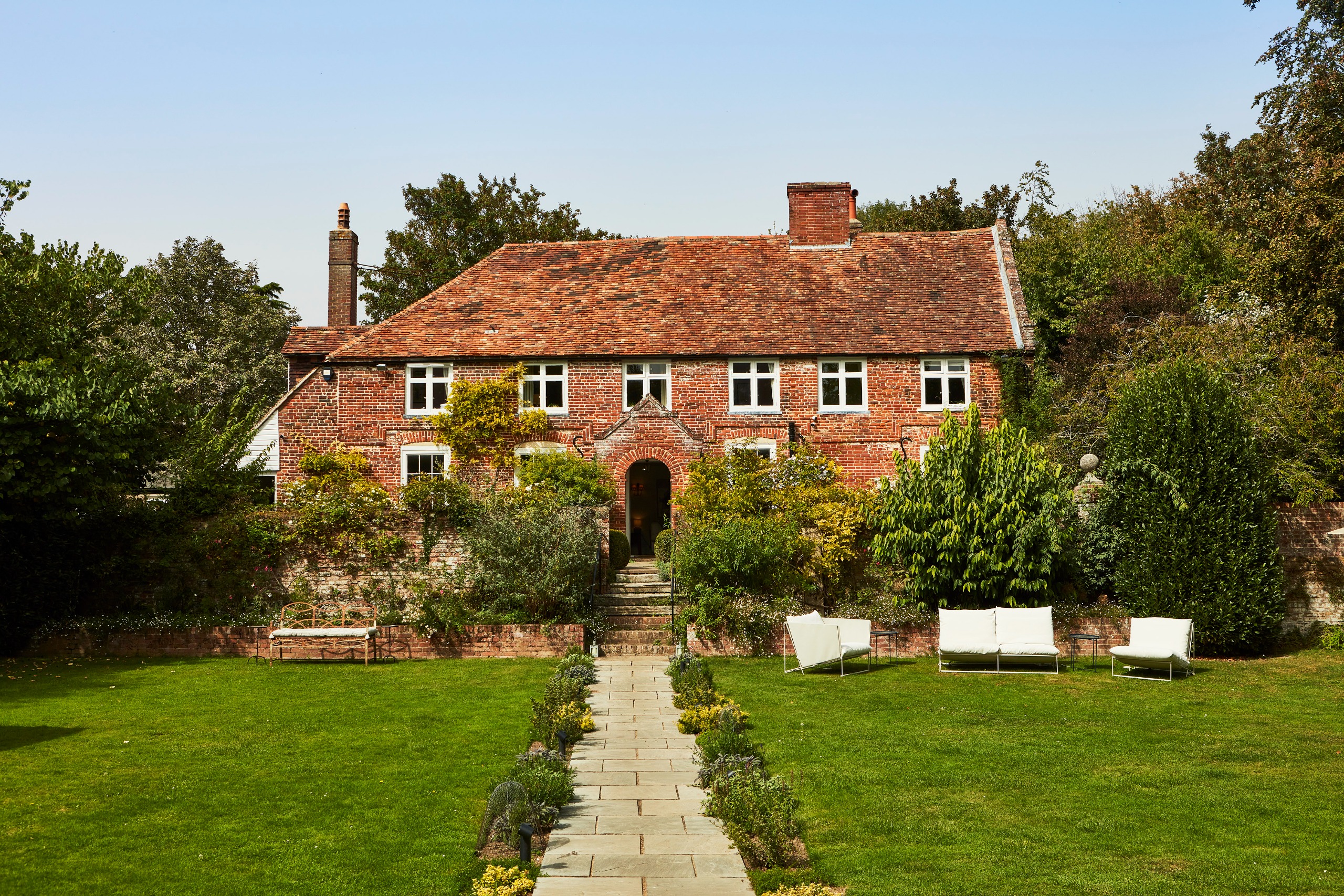 Restored red brick farmhouse with jewel-tone interiors