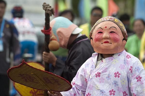 Performers in masks were part of the pre-stage festivities in Wenchang.