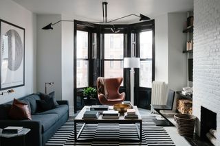 grey living room with black and white striped rug by BHDM Design