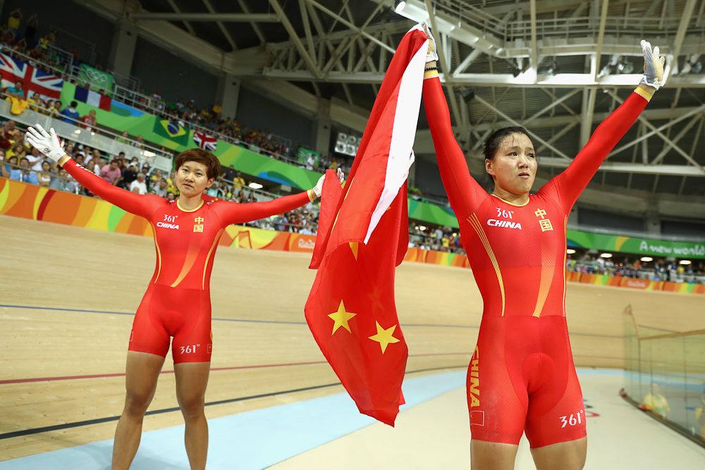 Jinjie Gong (R) and Tianshi Zhong (L) of Team China celebrates winning the gold medal after beating Team Russia in the Women's Team Sprint