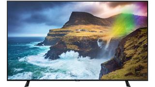 The Samsung Q70 QLED TV pictured against a white background and displaying waves crashing against cliffs.