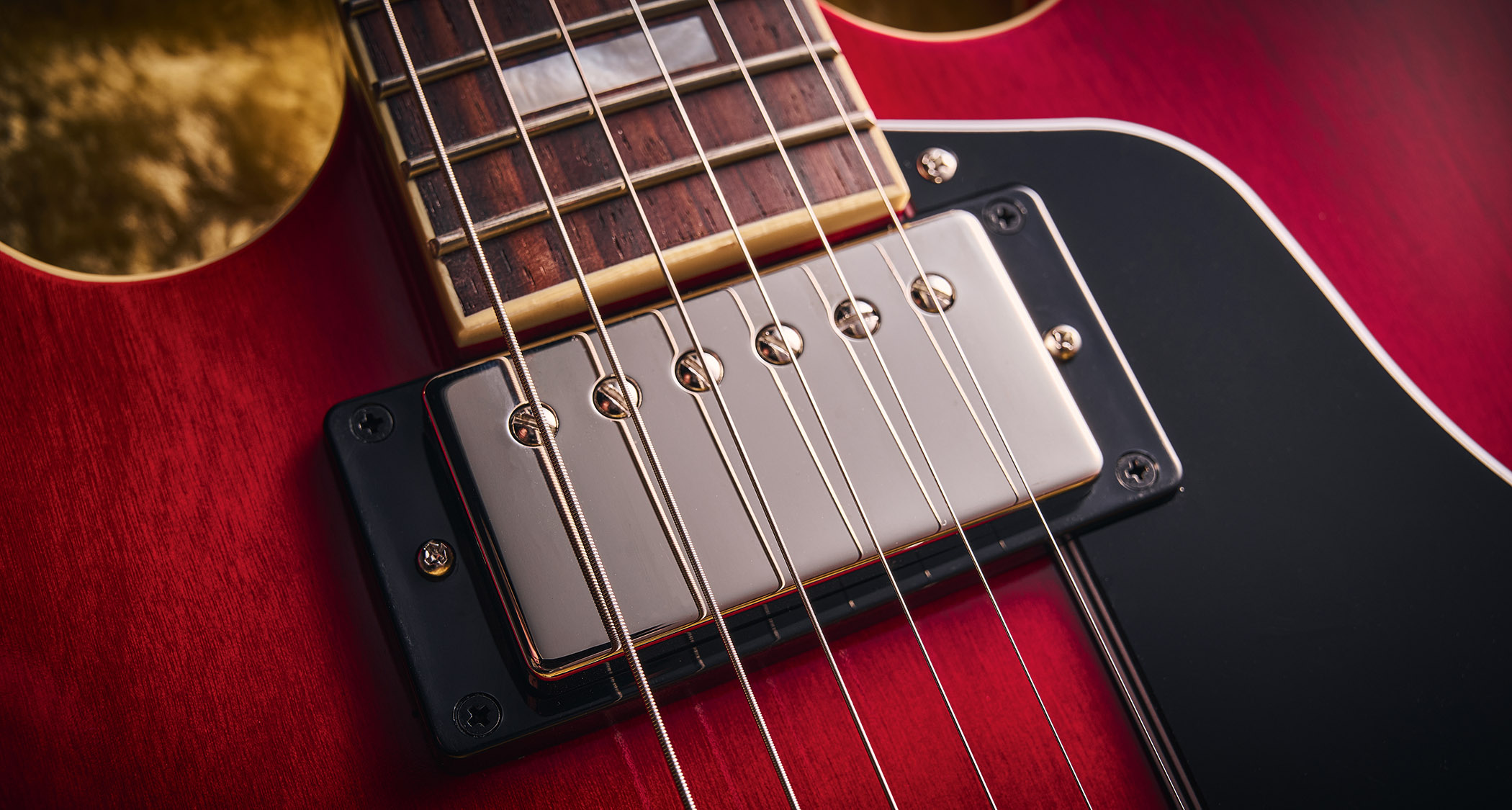 Epiphone Inspired By Gibson Custom 1962 ES-335 Reissue: the handsome semi-hollow electric is finished in Sixties Cherry and is photographed against various backgrounds.