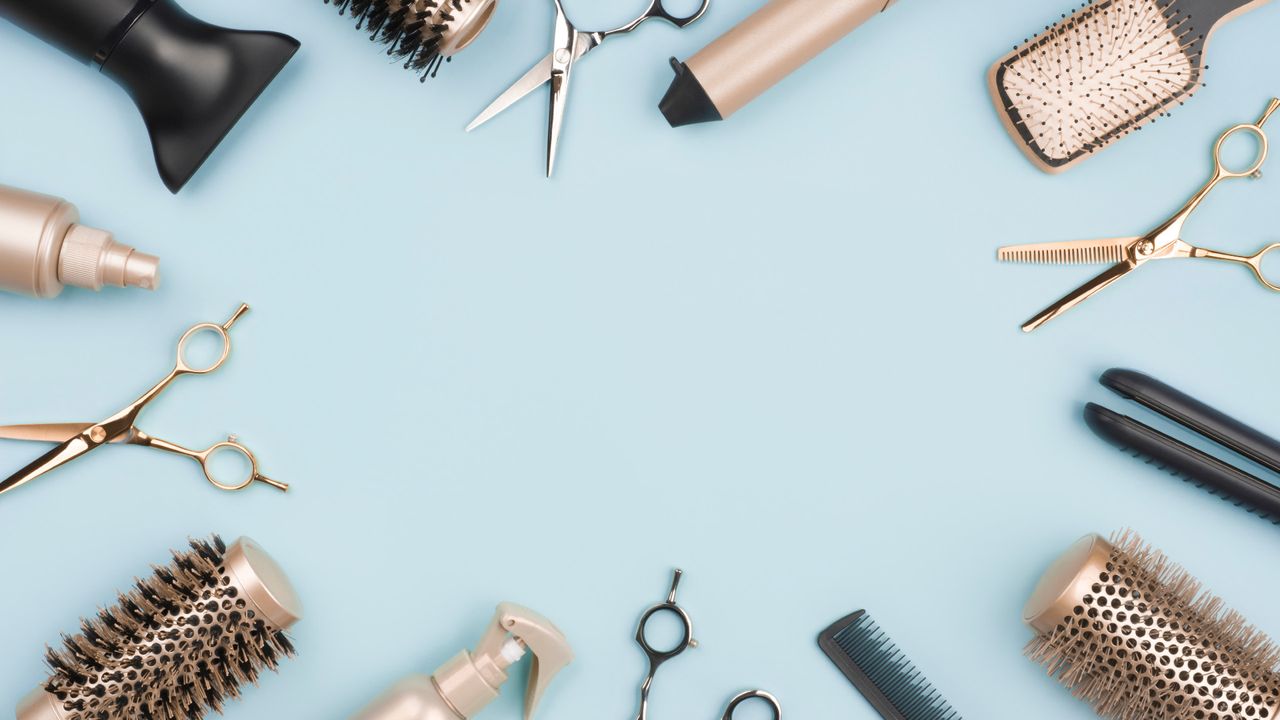 Blue background with various hair dryers and tools