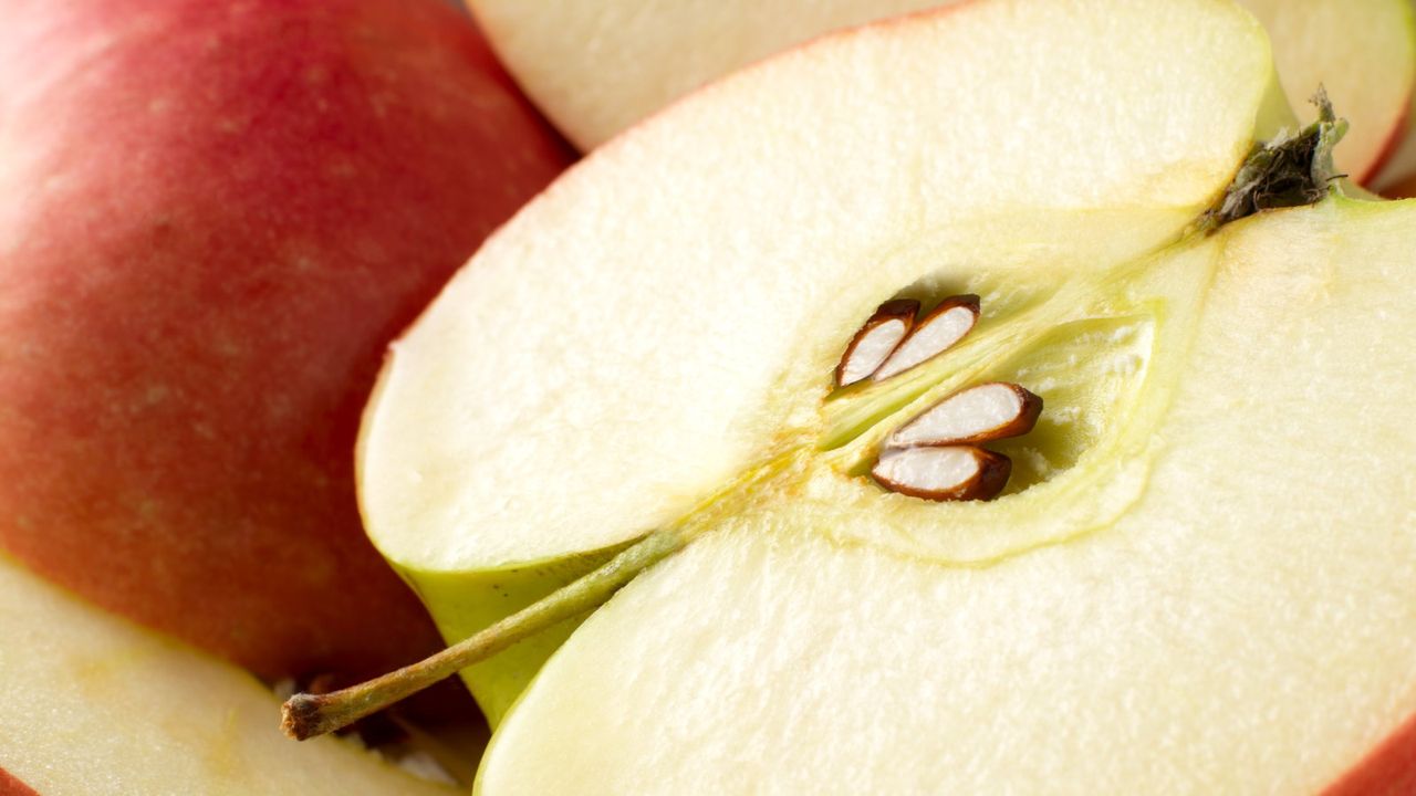 An apple cut in half to reveal the seeds