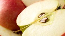 An apple cut in half to reveal the seeds