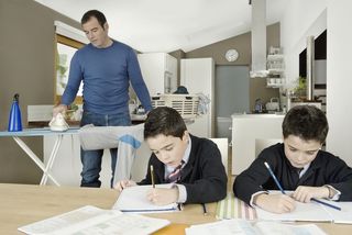 Father doing housework with kids.